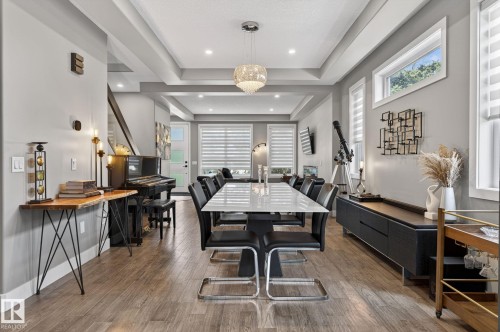 Open-concept living space featuring wood-finish flooring, recessed lighting, and a coffered ceiling - 8809 148 Street, Edmonton, AB - Indoor Photo Showing Dining Room