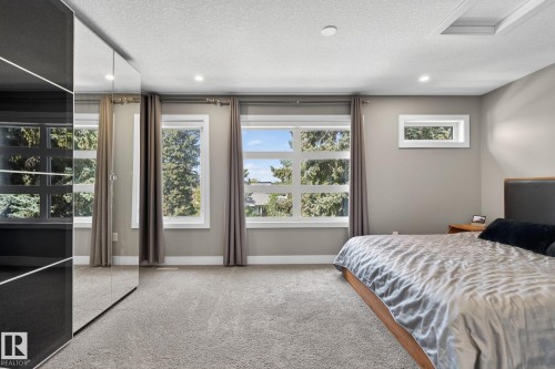 Wall-to-wall carpeting with multiple windows providing natural light - 8809 148 Street, Edmonton, AB - Indoor Photo Showing Bedroom