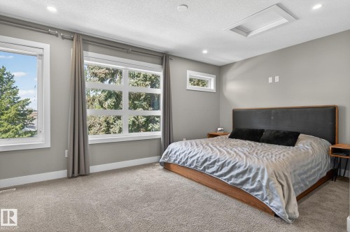 Carpeted room featuring multiple windows with trim, recessed lighting, and a ceiling light panel - 8809 148 Street, Edmonton, AB - Indoor Photo Showing Bedroom