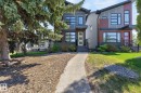 Contemporary split-level duplex featuring multi-toned siding, black-framed windows, and contrasting entry doors - 8809 148 Street, Edmonton, AB  - Outdoor With Facade 
