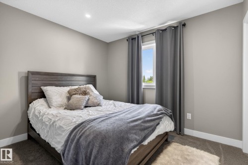 Carpeted room featuring neutral wall tones, white trim, a window with dark curtains, and a recessed ceiling light - 8809 148 Street, Edmonton, AB - Indoor Photo Showing Bedroom