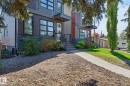 Contemporary exterior with vertical and horizontal siding, stone accent cladding, multi-pane windows, and a paved walkway leading to the entrance - 8809 148 Street, Edmonton, AB  - Outdoor 