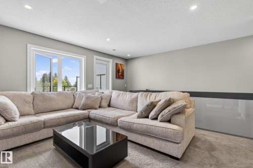 Recessed lighting illuminating a spacious room with light gray walls and plush carpet flooring - 8809 148 Street, Edmonton, AB - Indoor Photo Showing Living Room