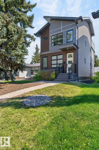 Modern exterior featuring a prominent gabled roofline and a combination of grey and brown siding - 8809 148 Street, Edmonton, AB - Outdoor