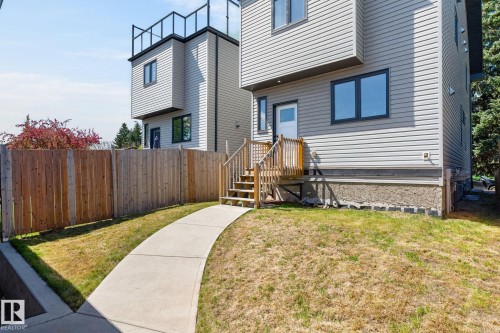 Contemporary multi-level residence featuring light gray siding and dark-trimmed windows - 8809 148 Street, Edmonton, AB - Outdoor