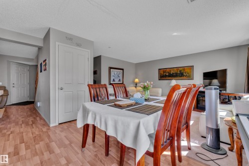 Dining area featuring wood-finish flooring and a neutral color palette - 14031 136 Street, Edmonton, AB 
