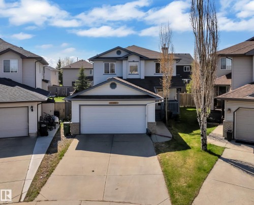 Two-story residence featuring a front-facing attached garage and a concrete driveway - 14031 136 Street, Edmonton, AB 