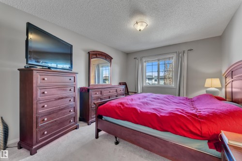 Bedroom featuring a window with natural light, light gray walls, and carpet flooring - 14031 136 Street, Edmonton, AB 