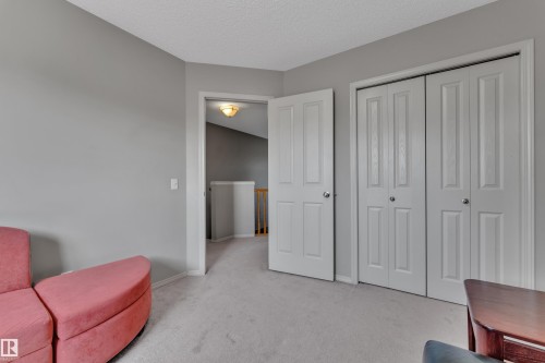 Room featuring neutral gray walls, light gray carpet flooring, and white trim - 14031 136 Street, Edmonton, AB 