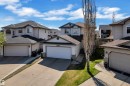 Two-story property featuring light-colored siding and a dark shingle roof - 14031 136 Street, Edmonton, AB 