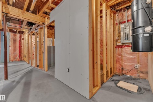 Unfinished basement space featuring exposed wooden framing, a concrete floor, and insulation - 14031 136 Street, Edmonton, AB 