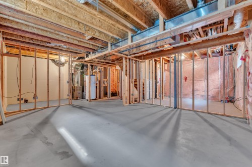 Unfinished basement with concrete flooring, exposed wood framing, and visible ductwork - 14031 136 Street, Edmonton, AB 