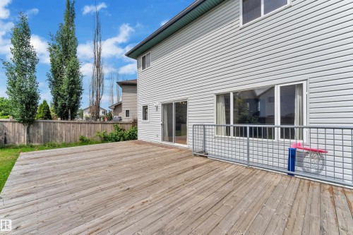Expansive wood deck with a metal grid railing - 14031 136 Street, Edmonton, AB 