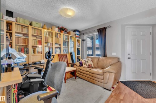 Dedicated space with extensive built-in shelving, wood-finish flooring, and a multi-pane exterior door - 14031 136 Street, Edmonton, AB 