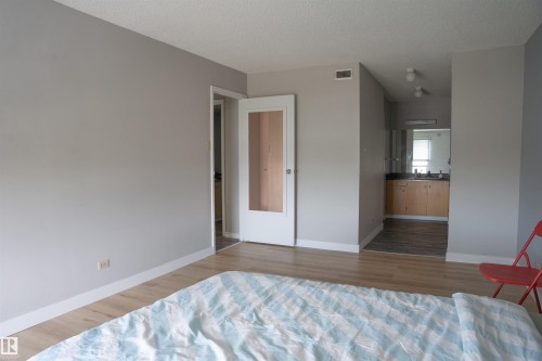 Bedroom featuring wood-finish flooring and light gray painted walls - 1703 11027 87 Avenue N, Edmonton, AB - Indoor Photo Showing Bedroom