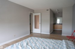 Bedroom featuring wood-finish flooring and light gray painted walls - 