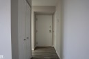 Entryway featuring wood-finish flooring, white walls, and a textured ceiling - 1703 11027 87 Avenue N, Edmonton, AB  - Indoor Photo Showing Other Room 
