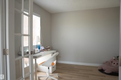Room featuring French doors with glass panels, light wood-finish flooring, and neutral wall tones - 