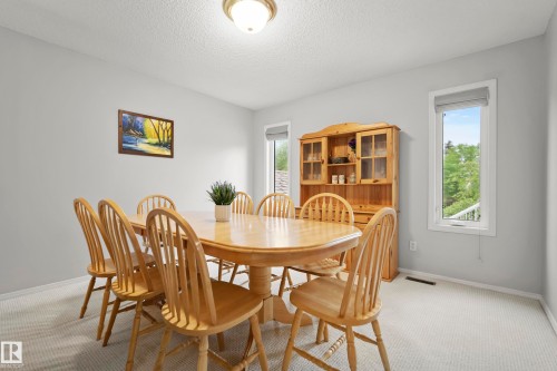 Dining space with neutral wall color and light-toned carpet flooring - 15503 62 Street, Edmonton, AB 