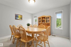 Dining space with neutral wall color and light-toned carpet flooring - 