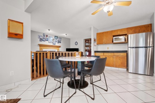 Kitchen area featuring white tiled flooring and a ceiling fan - 15503 62 Street, Edmonton, AB 
