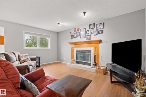 Living area featuring light wood-finish flooring and neutral wall tones - 15503 62 Street, Edmonton, AB 