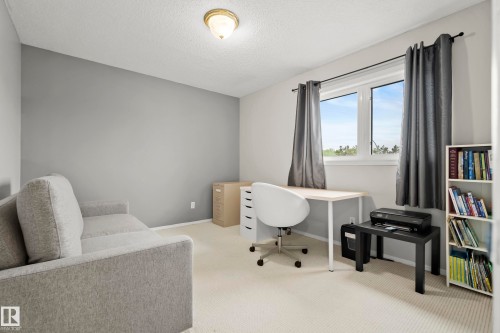 Light-colored carpeted flooring extends throughout this room, featuring light gray walls - 15503 62 Street, Edmonton, AB 