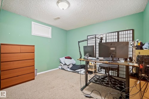 Carpeted interior room featuring light green walls and a white textured ceiling - 15503 62 Street, Edmonton, AB 