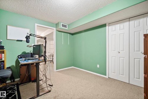 Carpeted room with light green walls and textured ceiling - 15503 62 Street, Edmonton, AB 
