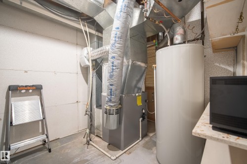 Utility area featuring a water heater, furnace, and exposed ductwork - 15503 62 Street, Edmonton, AB 
