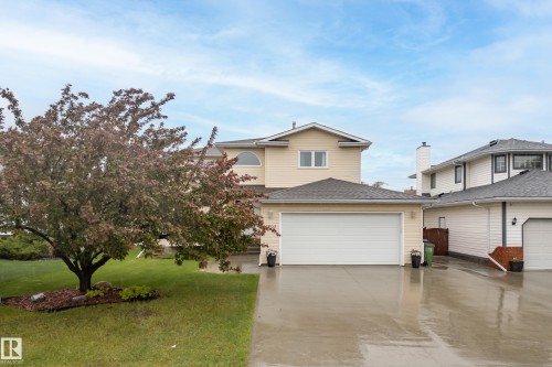 Two-story home with light-colored siding and a dark shingled roof - 15503 62 Street, Edmonton, AB 