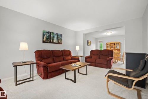 Carpeted living area featuring light gray walls and a recessed doorway - 15503 62 Street, Edmonton, AB 