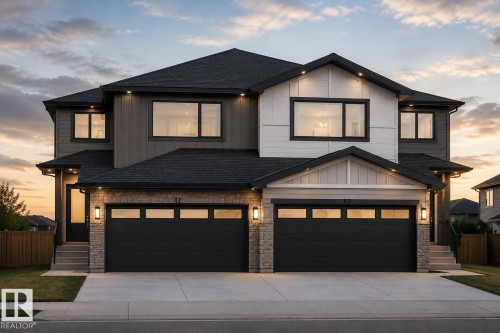 Modern duplex exterior featuring a dark asphalt shingle roof, stone and siding façade, black garage doors with frosted window inserts, and exterior wall sconces - 3620 40 Avenue, Beaumont, AB 