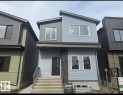 Contemporary two-story exterior with light blue horizontal siding and dark gray vertical siding - 206 Starling Way, Fort Saskatchewan, AB  - Outdoor With Exterior 