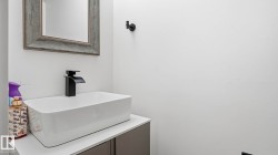 Modern vanity featuring a rectangular vessel sink with a matte black waterfall faucet - 