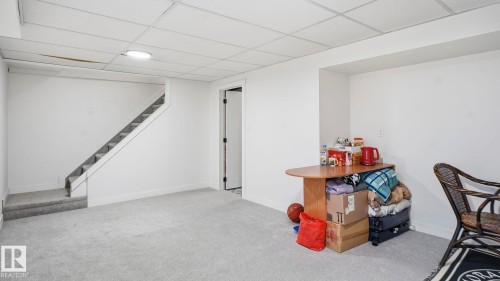 Lower level with light gray carpet flooring, white painted walls, a drop ceiling, and recessed lighting - 20C Callingwood Court, Edmonton, AB - Indoor Photo Showing Other Room