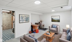Finished basement area featuring recessed lighting, a drop ceiling, and light gray flooring - 