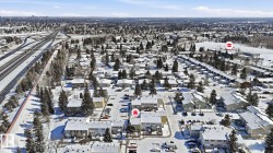 Aerial representation of a residential area with multiple townhome-style buildings, interspersed with detached homes - 