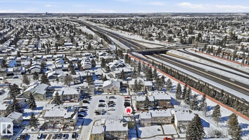 Aerial perspective showcasing a residential area with snow-covered rooftops and mature trees - 20C Callingwood Court, Edmonton, AB - Outdoor With View