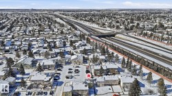 Aerial perspective showcasing a residential area with snow-covered rooftops and mature trees - 
