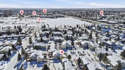 Aerial perspective showcasing a residential neighborhood with snow-covered rooftops and streets - 