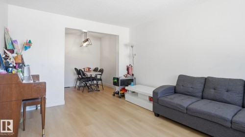 Open-concept living area with light wood-finish flooring - 20C Callingwood Court, Edmonton, AB - Indoor Photo Showing Living Room