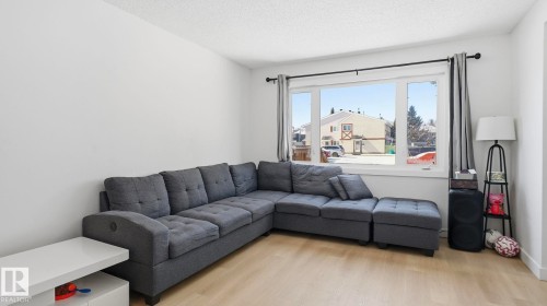 Bright living area featuring light wood-finish flooring - 20C Callingwood Court, Edmonton, AB - Indoor Photo Showing Living Room