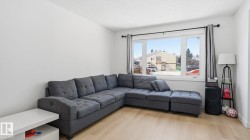Bright living area featuring light wood-finish flooring - 