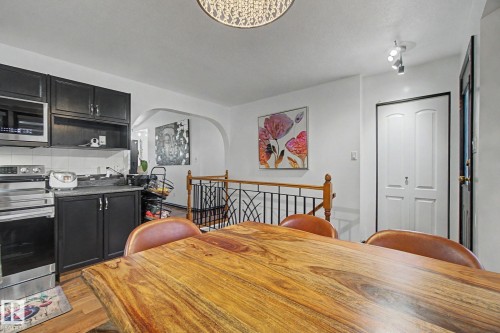 Dining area featuring a prominent wood-finish tabletop - 242 Northmount Drive, Wetaskiwin, AB 