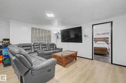 Spacious room featuring light wood-finish flooring, white walls, and a recessed ceiling light - 242 Northmount Drive, Wetaskiwin, AB 