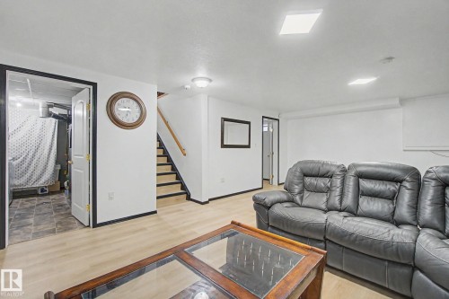 Finished basement space featuring light wood-finish flooring, white walls, and recessed ceiling lighting - 242 Northmount Drive, Wetaskiwin, AB 