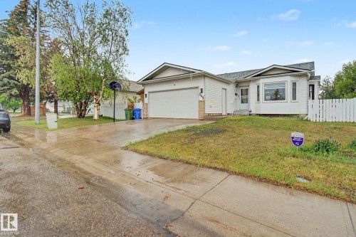 Ranch-style residence featuring white siding, a prominent bay window, and an attached garage - 242 Northmount Drive, Wetaskiwin, AB 