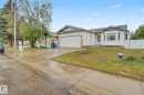 Ranch-style residence featuring white siding, a prominent bay window, and an attached garage - 242 Northmount Drive, Wetaskiwin, AB 