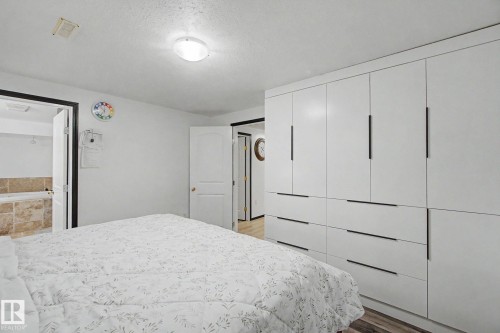 Built-in white cabinetry with matte black hardware - 242 Northmount Drive, Wetaskiwin, AB 